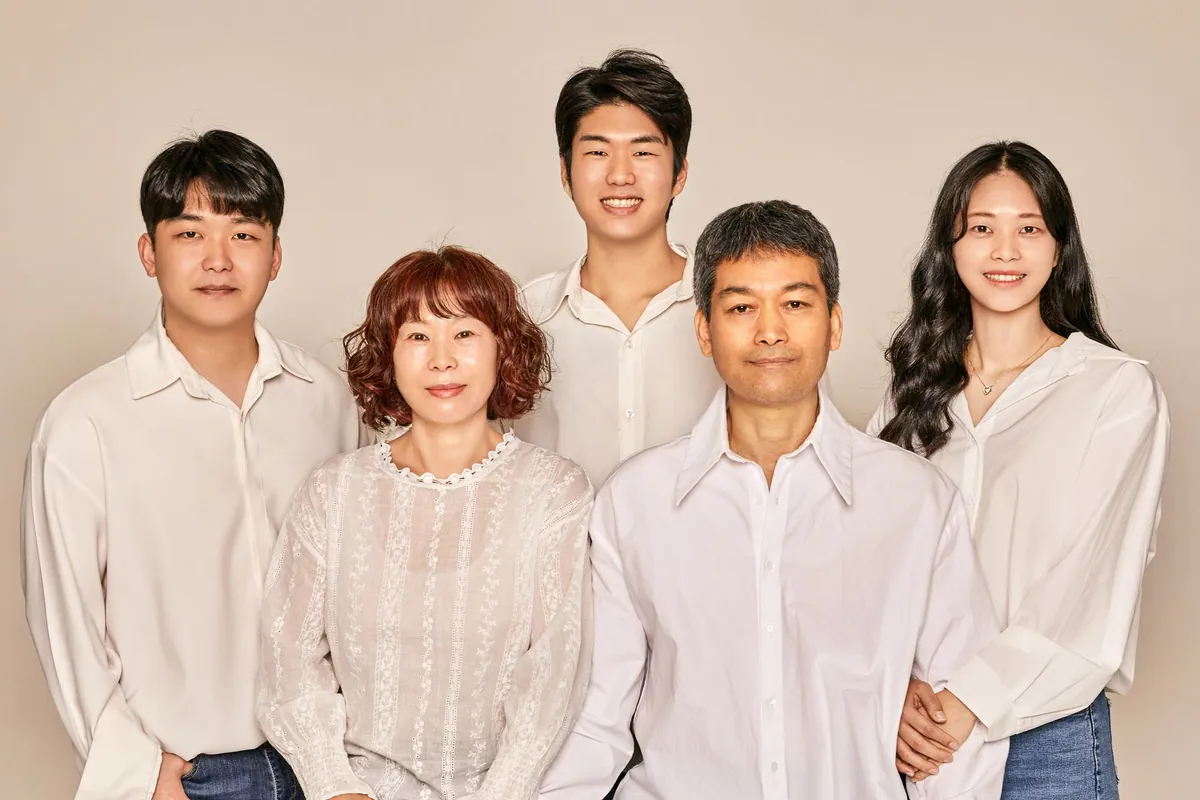 A smiling family of five posing together for a portrait