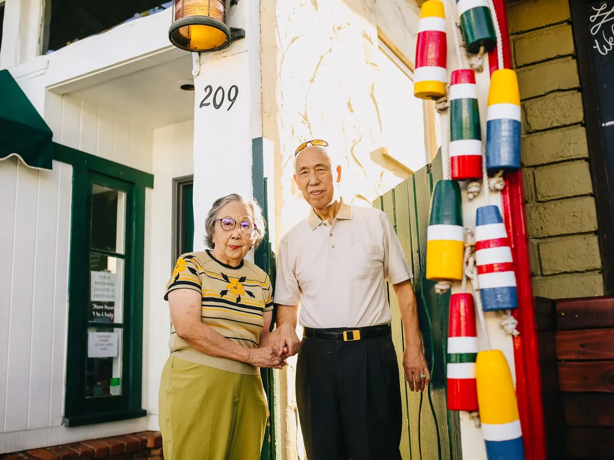 A senior couple holding hands and smiling